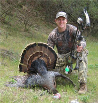 bow hunter with turkey